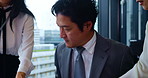 Japanese, businessman and stress in multitasking for ideas, teamwork and documents at office. Male person, thinking and colleagues with time management, anxiety or reading paperwork in finance agency