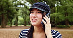 Japanese woman, park and conversation with phone call for talking, listening and gossip with contact. Nature, female person and smile with mobile for communication, vacation update and travel outdoor