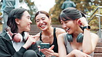 Exercise, phone and steps with Japanese women outdoor together for cardio, training or workout. Break, fitness and smile of athlete friends on stairs for communication, tracking or update with app