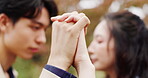 Couple, trust and holding hands for support outdoor with commitment, respect and loyalty in relationship. Japanese people, closeup and bonding together in nature with love and intimate moment on date