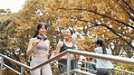 Happy, women and running on stairs for fitness, exercise and cardio training in Tokyo park. Japanese people, friends and jogging on steps with smile, routine and marathon preparation with endurance