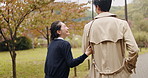 Umbrella, laughing and Japanese couple in park for love, funny and bonding together. Commitment, support and date with asian man and woman walking in nature for care , honeymoon and network.