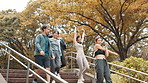 Fitness, stretching and walking on steps with friends outdoor in park for start of cardio workout routine. Conversation, exercise and warm up with Japanese people in nature for health or training