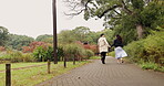 Holding hands, running and Japanese couple in park for love, partner and bonding together. Commitment, freedom and happy with asian man and woman on date in nature for care, honeymoon and vacation