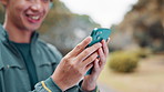Hands, fitness and person with phone in park searching for online exercise program for health. Sports, cellphone and athlete typing on browsing website for workout routine outdoor in Japanese field.