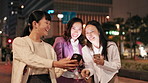 Japanese women, phone and walking with social media, happy news or comic information in city. Friends, smile and commute with smartphone for networking, funny meme or mobile communication in Tokyo