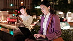 Night, woman and laptop in city for business deadline, planning and typing in Tokyo. Dark, Japanese workaholic and computer on sidewalk with commitment, research project and networking at bokeh