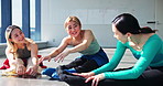 Fitness, class and friends stretching legs on floor in studio for health, body wellness and talking. Happy group, flexibility and women warm up muscle, dancers exercise and Japanese girls laughing