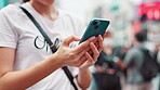 Woman, typing and hands with phone in city for online networking, text message and email response. Japanese person, smartphone and internet search for travel location, urban town map or navigation