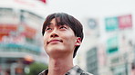 Adventure, asian man and thinking with city for sightseeing, inspiration or travel in Japan. Japanese, male person or tourist with smile or wonder for destination, dream or location in town or Tokyo