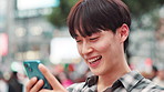Man, typing and laughing with phone in city for online networking, funny text message and email response. Japanese person, smartphone and happy with internet meme, social media joke and communication