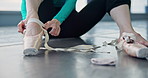 Woman, hands and ballet dancer with shoe for performance, rehearsal or practice on floor at studio. Japanese, closeup or female person tying straps, feet and toes getting ready for ballerina dancing