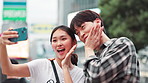 Happy, asian couple and selfie with expression in city for photography, memory or picture in Tokyo. Japanese, man and woman with smile, peace sign or emoji for capture, moment or travel in urban town