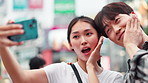 Happy, asian couple and selfie with photography in city for memory or picture together in Tokyo. Japanese, man and woman with smile, peace sign or emoji for capture, moment or travel in an urban town