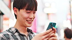 Man, typing and happy with smartphone in city for online networking, text message or email response. Japanese person, phone and smile with internet search for travel location or urban town navigation