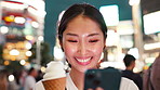 Woman, phone and happy with ice cream in city at night with travel, texting and contact on mobile app. Person, girl and smartphone in street with cone, gelato and desert with social media in Japan