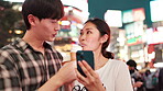 Bonding, night and couple with smartphone, city and smile for live stream, love and vlogger in holiday. Outdoor, eating and influencer with ice cream, fun and Japanese people on vacation and Tokyo