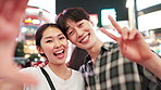 Happy, asian couple or night with peace sign for selfie, memory or picture together in Tokyo city. Portrait, japanese man and woman with smile for photography, moment or late evening bonding in Japan