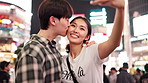 Happy, asian couple or night with kiss for selfie, memory or picture together in Tokyo city. Japanese, man and woman with smile, hug or love for app, photography or moment in an urban town of Japan