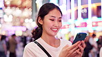 Woman, typing and happy with phone in town for online networking, text message and email response. Japanese person, smartphone and smile with internet search for travel location and city map at night