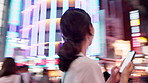 Woman, back and phone in city at night for travel, buildings and blur on urban sidewalk with search for direction. Person, smartphone and outdoor with app, thinking and check for location in Japan