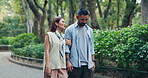 Couple, talking and holding hands in park for love, bonding and communication with romance or support. Man, woman and conversation outdoor for relationship, travel and tourism with holiday in Japan