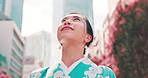 Japanese woman, kimono and travel in city with thinking, smile and outdoor with search, street or location. Person, happy and reflection with traditional clothes, memory and summer on urban sidewalk