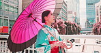 Woman, kimono and walking with umbrella of Japan, outdoor bridge and travel to city for view. Female person, traditional clothes and relax in town for culture, local fashion and exploring urban