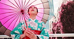 Woman, kimono and thinking with umbrella of Japan, outdoor bridge and travel to city for view. Female person, traditional clothes and relax in town for culture, local fashion and exploring urban