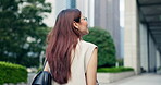 Travel, woman and walking outdoor in city for sightseeing, urban adventure and exploring Japan. Tourist, person and pedestrian on holiday abroad with buildings, scenery and commute on vacation 