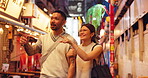 Pointing, night and couple on date, city and bonding on vacation, talking and romance for relationship. Travel, exploring and anniversary for people on holiday, tourism and love for heritage in Japan