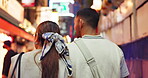 Back, night and couple on date, city and bonding on vacation, talking and romance for relationship. Travel, exploring and anniversary for people on holiday, tourism and love for heritage in Japan