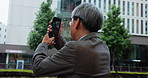 Mature, business man and picture of building in city for property development, urban infrastructure and inspiration. Professional, japanese person and photography of skyscraper architecture in town