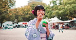 Smile, shaved ice and Japanese woman with walking, eating and traditional outdoor market in city. Kakigori, culture and girl in kimono with frozen dessert, summer festival and street food in park