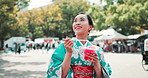 Kimono, fashion and Asian woman in city with drink on holiday, vacation and weekend in town. Travel, walking and Japanese person in tradition clothes, outfit and style with beverage explore outdoors