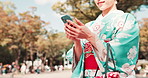 Hands, kimono and Asian woman in city with phone typing for social media, networking and communication. Travel, traditional fashion and Japanese person on smartphone for online map, website and chat