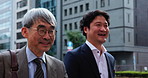 Walking, travel and team with business people in Japan city for mentor, conversation and client negotiation. Partnership, corporate and talking with men in outdoors for discussion and collaboration