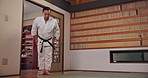Honor, asian man or bow in dojo for karate for respect, karate practice and self defense in class. Fighter, kneeling or male student in Japan for learning martial arts, combat training or workout