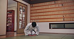 Respect, Asian man or bow in dojo for karate for honor, kung fu practice and self defense in class. Fighter, kneeling or male student in Japan for learning martial arts, combat training or workout