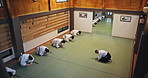 Aikido, martial arts and bow in class, fitness and respect with gratitude, appreciation and training. Japanese people, group and students with instructor, ritual and karate with sensei and education