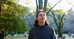 Japan, thinking and man with fitness, walking and routine with adventure, journey and wellness. Person, runner and athlete in park, sightseeing or travel with breathing and break with nature and calm