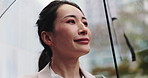 Rain, city walk and Japanese woman with umbrella and professional on morning commute in winter. Closeup, outdoor and cold weather on urban street with water drops, travel and Tokyo trip in storm