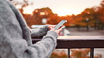 Hands, typing and woman on bridge with phone, connection or online chat on morning commute in city. Smartphone, search and girl with mobile app for social media post, texting or urban travel in Japan