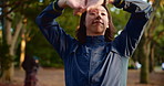 Fitness, happy and stretching with man in forest for start of cardio, training or workout routine. Exercise, getting ready and warm up with smile of Japanese athlete in nature or park for sports