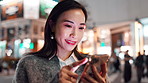 Business woman, phone and night in city with texting, reading and mobile app on travel with smile in road. Person, smartphone and happy in street with chat, notification and social network in Japan