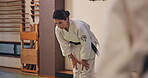 People, warm up and training in dojo for martial arts, aikido and fitness with class instructor in Japan. Sensei, stretching and exercise in Tokyo for karate practice, workout or muscle with students