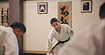 Training, learning and people in aikido class together for group challenge, fitness and muscle warm up in club. Culture, mentor and students in dojo for traditional Japanese martial arts exercise.
