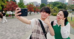 Happy, selfie and Asian couple with thumbs up in city for holiday, bonding and travel on weekend. Love, dating and Japanese man and woman with emoji take photo for social media, memory and post