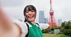 Influencer, city and selfie of Asian woman by Tokyo tower for social media, video call or online vlog. Happy, travel and portrait of Japanese person live streaming on holiday, adventure or vacation
