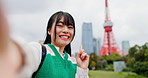 Influencer, happy and selfie of Asian woman by Tokyo tower for social media, video call or online vlog. City, travel and portrait of Japanese person live streaming on holiday, adventure and vacation